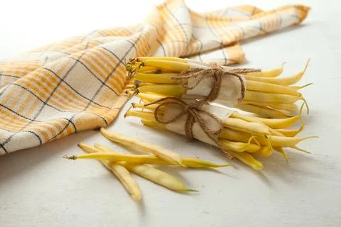 Several pods and two bunches of flat runner bean pods heap and yellow kitch.. Stock Photos