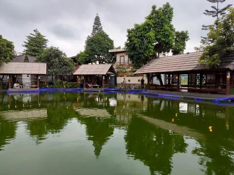 Several poolside dining huts at the "Darmaga Sunda" restaurant Stock Photos