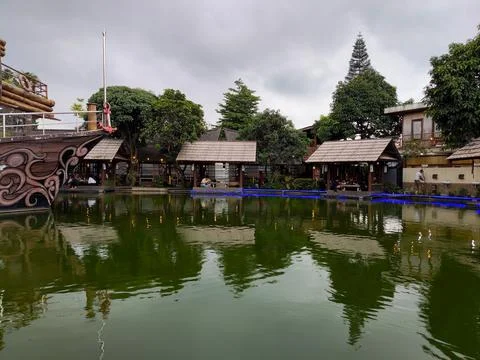 Several poolside dining huts at the "Darmaga Sunda" restaurant Stock Photos