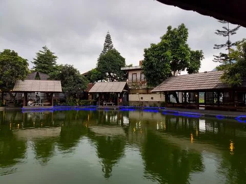 Several poolside dining huts at the "Darmaga Sunda" restaurant Stock Photos