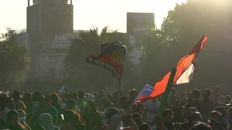 Several protesters raise the Chilean flag as a sign of struggle and resistanc Stock Footage 136342403