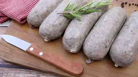 Several raw andouillettes on a cutting board Stock Footage 159500739