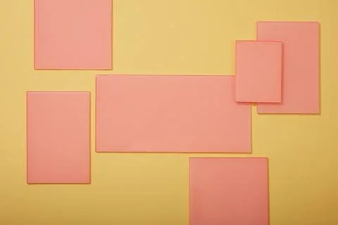 Several rectangle acrylic sheets in pink color are displayed on a light backg Stock Photos