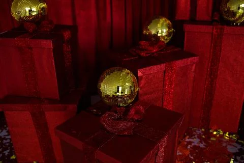 Several red gift boxes with golden balls and confetti Stock Photos