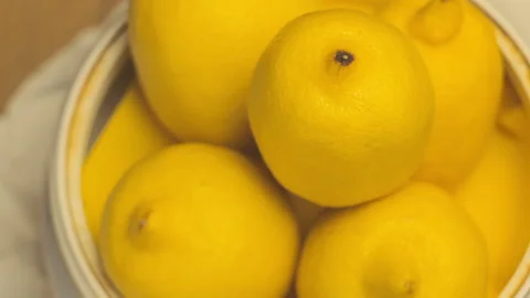 Several Ripe Lemons Lying In A Old-Time Bowl Video stock 97781259