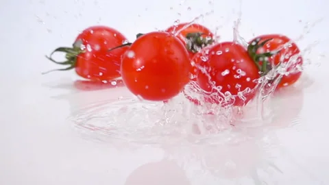 A Several Ripe Tomatoes are Falling on the Table Stock Footage 120093284
