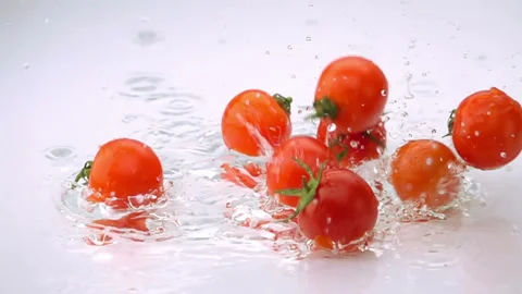 A Several Ripe Tomatoes are Falling on the Table Stock Footage 143971531