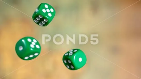 Several rolling green dice fall on a table with boardgame. Gameplay moments Stock Photos