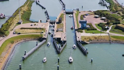 Several sailboats navigate through lorentzsluizen lock complex kornwerderzand 動画素材 327941753