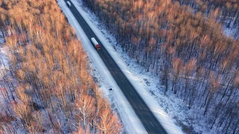 Several semi-trucks with trailers are coming from warehouses located in the Stock Footage 165383594