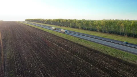 Several semi trucks with versatile semi trailers are going after each other Stock Footage 154096750