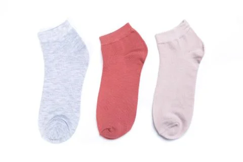 Several separate colored new short socks on a white background, top view Stock Photos