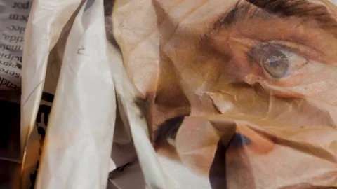 Several sheets of newspaper burning inside a metal container Stock Footage 110479348