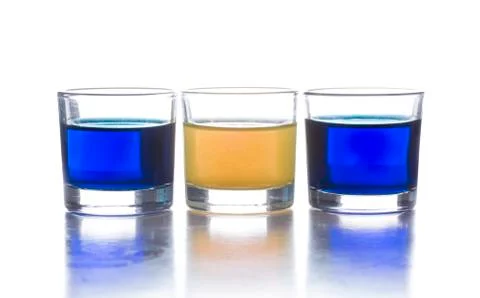 Several shot glasses with different drinks, which combined represent the flag Stock Photos