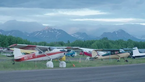 Several Single Engine Light Aircraft in Remote Mountain Airfield Stock Footage 83140399