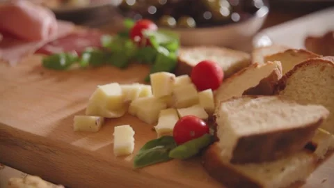 Several slices of cheese with cherry pomodor, basil and bruschetta Video stock 166318035