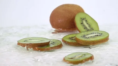 A Several Slices of Kiwi are Falling on the Table. Stockbeeldmateriaal 72450004