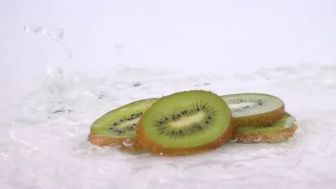 A Several Slices of Kiwi are Falling on the Table. Video stock 72835559