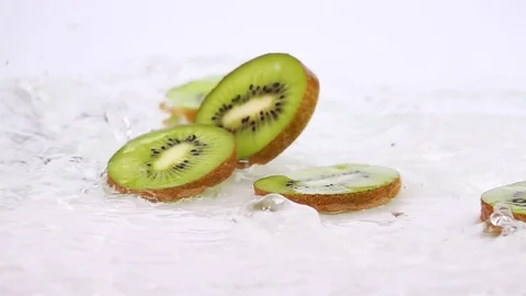 A Several Slices of Kiwi are Falling on the Table. Stock Footage 73039996