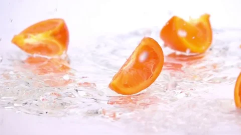 A Several Slices of Orange are Falling on the Table. Stock Footage 72840693