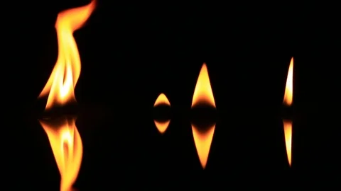 Several Small Flames Burn Over Black Mirror - Flames Die Out Stock Footage 104076965