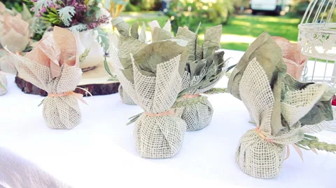 Several Small Gifts Packed in Burlap Bags Are on the Table. Wedding Decoration Stock Footage 61496365