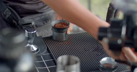 Several small needles evenly distribute the ground coffee beans. Stock Footage 243960711