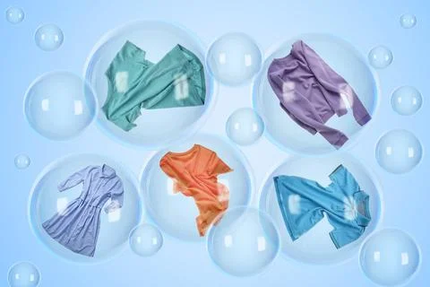 Several soap bubbles with clothes inside and empty ones floating on light b.. Stock Photos
