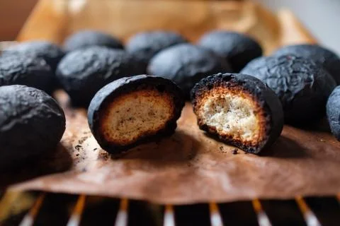 Several spoiled burnt black bread. Charred food. Stock Photos