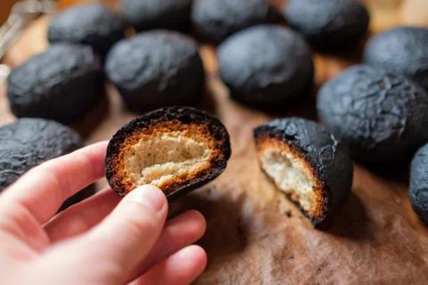Several spoiled burnt black bread. Charred food. Stock Photos