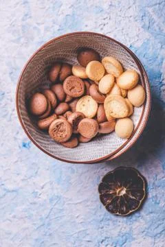Several sponge biscuits in bowl on light wooden board Stock Photos