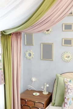 Several square and round frames for photographs and mirrors hang on the wall. Stock Photos