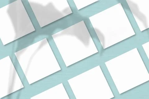 Several square sheets of white textured paper against a blue wall background. Stock Illustration