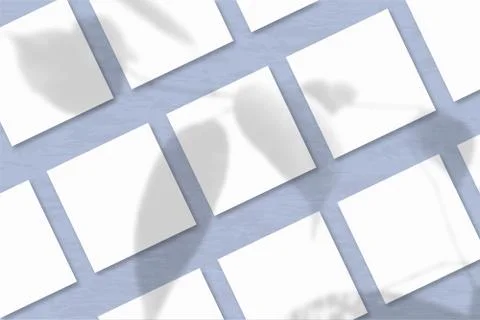 Several square sheets of white textured paper against a blue wall background. Stock Illustration