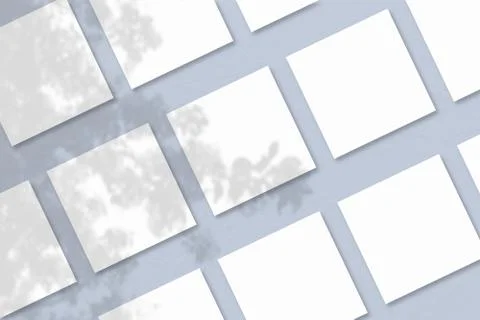 Several square sheets of white textured paper against a blue wall background. Stock Illustration