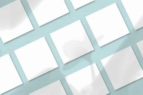 Several square sheets of white textured paper against a blue wall background. Stock Illustration
