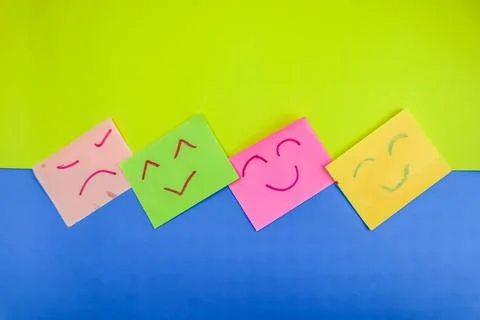 Several sticky notes with 4 expressions drawn with red and green markers on a Stock Photos