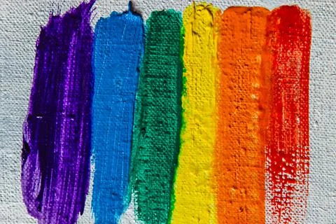 Several strokes of multi-colored paint depict a frag of the LGBT community on Stock Photos