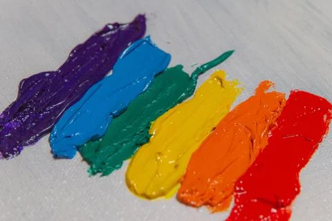 Several strokes of multi-colored paint depict a frag of the LGBT community on Stock Photos