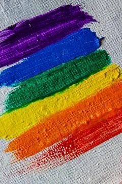 Several strokes of multi-colored paint depict a frag of the LGBT community on Stock Photos