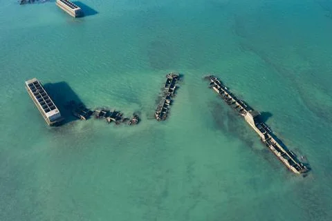 Several submerged elements of the artificial port of Gold beach in Asnelles seen 스톡 사진
