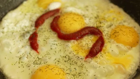 Several sunny-side-up eggs are frying in a frying pan. Stock Footage 327586488