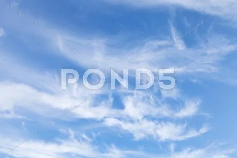 Several swirling small white clouds Stock Photos