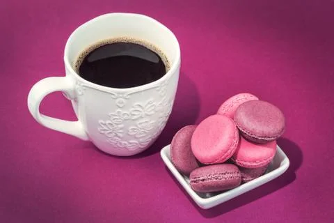 Several tasty pink macaroons in bowl and coffee Stock Photos
