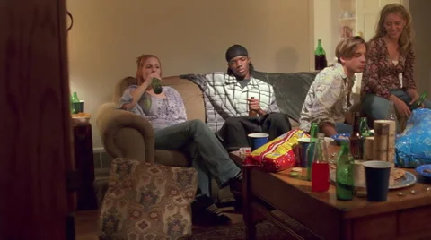 Several teenagers drinking alcohol at an unsupervised house party Stock Footage 59545687
