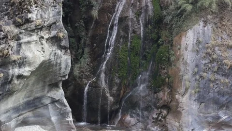 Several thin streams of waterfall flowing on steep mountain Stock Footage 75053215