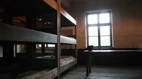 Several three-tiered beds, covered with old linens, during second world war 스톡 동영상 114629491