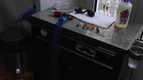 The several tools, inks and vaseline necessary to tattoo someone. The artists Stock Footage 125958992