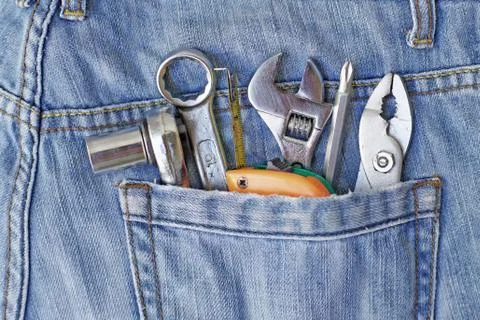 Several tools in workers pocket jeans Stock Photos