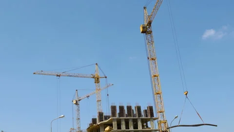 Several tower cranes build a multi-storey building and move cargo, middle plan,  Video stock 113116661